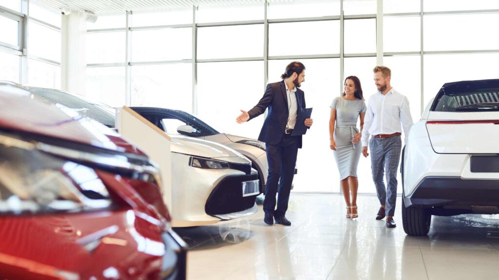 Vendeur automobile avec deux clients